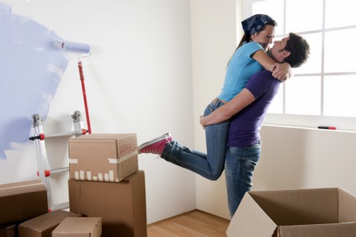 Professional movers carrying office furniture through a commercial property